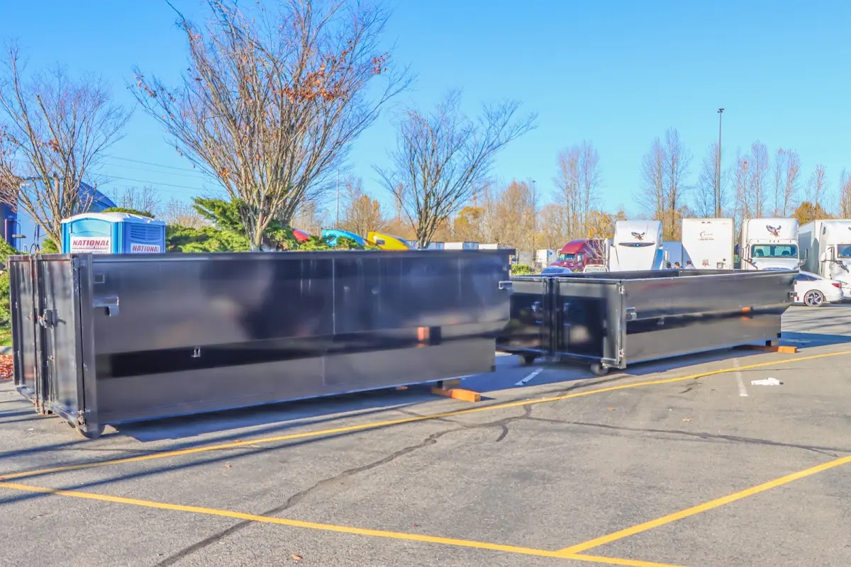 Professional dumpster rental service with roll-off container on residential driveway in Shelbyville